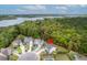 Aerial view of property with pool, lush surroundings, and close proximity to a lake at 1996 Wild Indigo Way, Hanahan, SC 29410