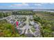 Aerial view of a residential neighborhood with lush greenery, a pond, and homes featuring private pools at 1996 Wild Indigo Way, Hanahan, SC 29410