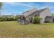 Expansive backyard featuring a deck with a screened porch, outdoor kitchen, and stone fireplace at 1996 Wild Indigo Way, Hanahan, SC 29410