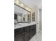 Bathroom featuring dark cabinets, a white countertop, decorative artwork, and large mirror at 1996 Wild Indigo Way, Hanahan, SC 29410
