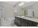 This bathroom features a tub, shower, and dual-sink vanity at 1996 Wild Indigo Way, Hanahan, SC 29410