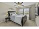 Comfortable bedroom with a stylish headboard, ceiling fan, and sunlit windows at 1996 Wild Indigo Way, Hanahan, SC 29410
