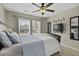 Bright bedroom featuring a modern ceiling fan, large windows, and mounted TV at 1996 Wild Indigo Way, Hanahan, SC 29410