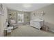 This Bedroom features a white crib, chandelier, and comfortable rocking chair at 1996 Wild Indigo Way, Hanahan, SC 29410