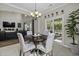 Inviting dining area with stylish chandelier, wood table, and natural light from sliding doors at 1996 Wild Indigo Way, Hanahan, SC 29410