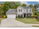 Charming two-story home with a well-manicured lawn, attached garage, and inviting curb appeal at 1996 Wild Indigo Way, Hanahan, SC 29410