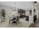 Modern kitchen with stainless steel appliances and dark cabinets adjacent to the dining area at 1996 Wild Indigo Way, Hanahan, SC 29410