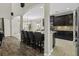 Open-concept kitchen featuring dark cabinetry, granite countertops, stainless steel appliances, and bar stool seating at 1996 Wild Indigo Way, Hanahan, SC 29410
