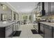 Well-equipped kitchen with black cabinets, stainless appliances, and an eat-in dining area at 1996 Wild Indigo Way, Hanahan, SC 29410