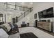 Well-appointed living room featuring staircase, high ceilings, comfortable seating, and hardwood flooring at 1996 Wild Indigo Way, Hanahan, SC 29410