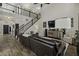 Elegant living room featuring a staircase, two-story ceiling, dark furniture, and hardwood flooring at 1996 Wild Indigo Way, Hanahan, SC 29410