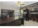 Office space featuring modern desk, shelves, arcade game, and accent brick wall at 1996 Wild Indigo Way, Hanahan, SC 29410