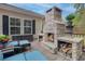 Inviting patio with a stone fireplace, ample seating, and wood storage for cozy evenings at 1996 Wild Indigo Way, Hanahan, SC 29410