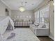 Bright playroom with a decorative chandelier, cozy seating, and organized storage for toys and books at 1996 Wild Indigo Way, Hanahan, SC 29410