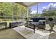 Cozy screened porch offers comfortable seating, stylish rug, and views of the landscaped yard at 1996 Wild Indigo Way, Hanahan, SC 29410