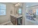 Ensuite bathroom with dual sinks, a large mirror, and an opening to the main bedroom at 2001 Poplar Grove Pl, Summerville, SC 29483
