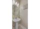 Cozy bathroom with pedestal sink, round mirror, and beach-themed decor at 2001 Poplar Grove Pl, Summerville, SC 29483