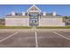 Community clubhouse with a parking lot on a bright sunny day at 2001 Poplar Grove Pl, Summerville, SC 29483