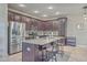 Well-lit kitchen with granite countertops, stainless steel appliances, and dark wood cabinets at 2001 Poplar Grove Pl, Summerville, SC 29483