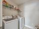 Modern laundry room with front loading washer and dryer and storage shelf at 2001 Poplar Grove Pl, Summerville, SC 29483