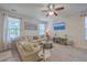 Bright living room featuring a large sectional sofa, ceiling fan, and mounted TV at 2001 Poplar Grove Pl, Summerville, SC 29483