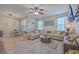 Bright living room featuring a large sectional sofa, ceiling fan, and mounted TV at 2001 Poplar Grove Pl, Summerville, SC 29483