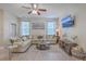 Bright living room featuring a large sectional sofa, ceiling fan, and mounted TV at 2001 Poplar Grove Pl, Summerville, SC 29483