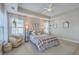 Well-lit main bedroom featuring tray ceiling, hardwood floors, many windows and neutral decor at 2001 Poplar Grove Pl, Summerville, SC 29483