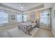 Spacious main bedroom with tray ceiling, many windows, and hardwood floors at 2001 Poplar Grove Pl, Summerville, SC 29483