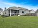 Home with a screened in porch and a large backyard offers an ideal outdoor living space for relaxation and entertaining at 215 Sweet Cherry Ln, Summerville, SC 29486