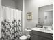 Cozy bathroom featuring a floral shower curtain and a vanity with a framed mirror at 215 Sweet Cherry Ln, Summerville, SC 29486
