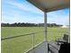 Relaxing screened-in porch with chairs overlooks vast, green lawn and mature trees in this desirable community at 215 Sweet Cherry Ln, Summerville, SC 29486