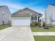 Well maintained single Gathering home includes a two car garage and a manicured lawn at 215 Sweet Cherry Ln, Summerville, SC 29486