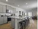 Open kitchen boasts gray cabinets, stainless appliances, and a granite-topped island with barstool seating at 215 Sweet Cherry Ln, Summerville, SC 29486