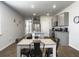 Open kitchen layout with gray cabinets, granite countertops, and stainless steel appliances at 215 Sweet Cherry Ln, Summerville, SC 29486