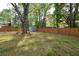 Spacious backyard with lush lawn, wooden privacy fence, and a charming storage shed providing outdoor space at 2158 Till Rd, Charleston, SC 29414