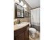 Bathroom features a modern vanity with granite counters, bronze fixtures, and a shower with a stylish curtain at 2158 Till Rd, Charleston, SC 29414