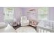 Charming Bedroom with lilac walls, white furniture, and natural light creating a cozy space for your baby at 2158 Till Rd, Charleston, SC 29414