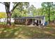Exterior view of the home showcasing a patio, fire pit, and backyard, great for outdoor enjoyment at 2158 Till Rd, Charleston, SC 29414