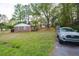 Exterior view of the home and the surrounding fenced yard at 2158 Till Rd, Charleston, SC 29414