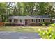 Charming brick home with a well-manicured lawn and vibrant flower bushes at 2158 Till Rd, Charleston, SC 29414