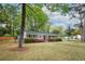 Beautiful home featuring brick facade, dark shutters, and lush landscaping at 2158 Till Rd, Charleston, SC 29414