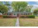 Charming brick home with beautiful landscaping and a well-manicured front lawn at 2158 Till Rd, Charleston, SC 29414