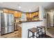 Kitchen featuring modern stainless steel appliances, wooden cabinets, and bar seating at 2158 Till Rd, Charleston, SC 29414