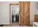 Laundry room view through sliding barn door, showing modern washer and dryer at 2158 Till Rd, Charleston, SC 29414