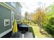 Backyard view with a hot tub next to the house, table, chairs, and yellow umbrella at 2160 Pentland Dr, Charleston, SC 29412