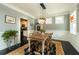 Dining room with traditional decor featuring a wooden table, area rug, black floors and stylish lighting at 2160 Pentland Dr, Charleston, SC 29412