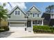 Charming two-story home with light green siding, a two-car garage, and a welcoming front porch at 2160 Pentland Dr, Charleston, SC 29412