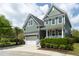 Charming two-story home with green siding, front porch, and well-manicured landscaping at 2160 Pentland Dr, Charleston, SC 29412