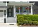 Welcoming front porch with white columns, flower baskets, and manicured hedges at 2160 Pentland Dr, Charleston, SC 29412